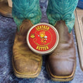 Load image into Gallery viewer, A close upof a brown pair of coboy boots with teal accents. The left boot is restored and moisturized with Leather Better while the right boots is cracked and faded.  A small tin of leather Better sits on top of the toes of the pair.