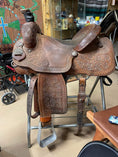 Load image into Gallery viewer, A western saddle prior to being treated with Leather Better is colour faded and showing its age.