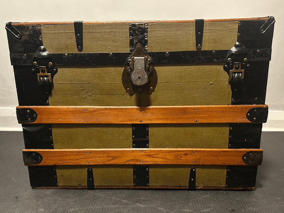 An antique trunk's canvas and wood gets restored and cleaned with Leather Better.