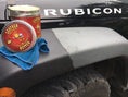 Load image into Gallery viewer, Front fender of a Jeep rubicon with an open can of Leather better. Half of the fender has been treated with Leather better.