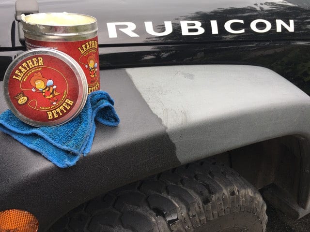 Front fender of a Jeep rubicon with an open can of Leather better. Half of the fender has been treated with Leather better.