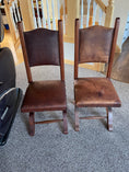Load image into Gallery viewer, Two wooden leather chairs. The chair on the left has been treated with Leather Better, and the chair on the right hasn't been treated with Leather better.