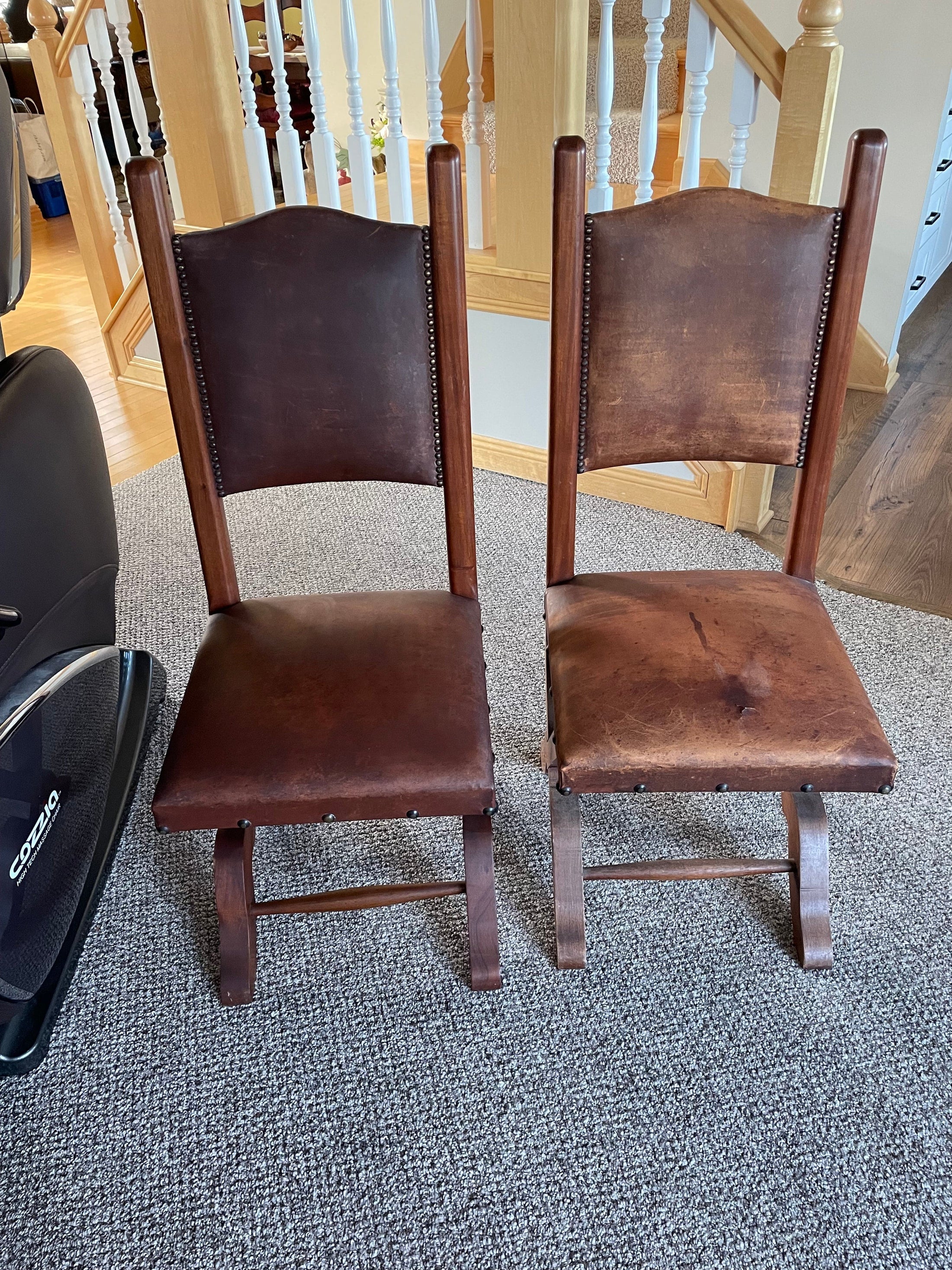 Two wooden leather chairs. The chair on the left has been treated with Leather Better, and the chair on the right hasn't been treated with Leather better.