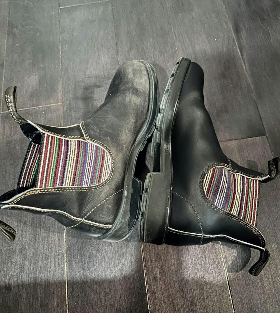 Pair of black blundstone boots with colourful stripped fabric. Left boot is untreated with Leather better, and the right is a treated boot with Leather better.
