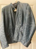 Load image into Gallery viewer, A faded blue motorcycle jacket with heavy wear prior to being treated with Leather Better.