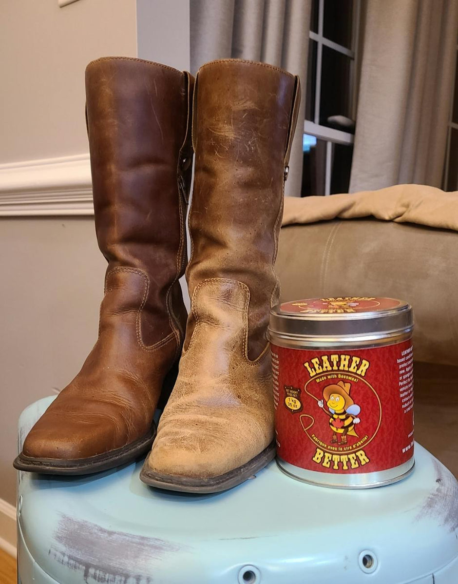 Side-by-side comparison of a pair of brown leather boots, with the right boot restored to a rich, even finish and the left boot showing heavy wear and discolouration. A large tub of Leather Better leather conditioner is placed beside the boots, highlighting the dramatic before-and-after results of using the product.