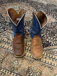 Load image into Gallery viewer, Blue and brown cowboy boots.  The right boot is treated showcasing a restored texture and colour while the left is untreated, worn, and dry.
