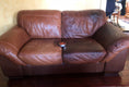 Load image into Gallery viewer, A dark brown leather loveseat with a can of Leather better sitting in the center of the couch. The left side of the couch hasn't been treated and is faded and scratched. The right side of the couch has been treated and restored.
