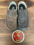 Load image into Gallery viewer, A pair of dark brown Olivia slippers on a table. The worn and faded slipper on the left is untreated and the slipper on the right is treated with Leather better.