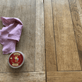 Load image into Gallery viewer, A image of a table mid restoration with leather better.  The left side is the before looking faded and grey whereas the right side has moisture back in the wood and the brown colour restored.