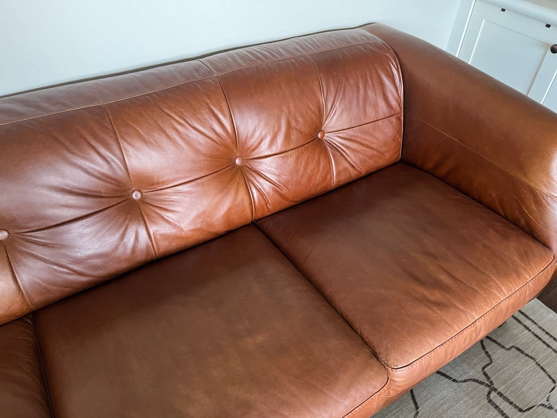 Tan brown retro couch after being treated with Leather Better. The scratches and cracks are gone.
