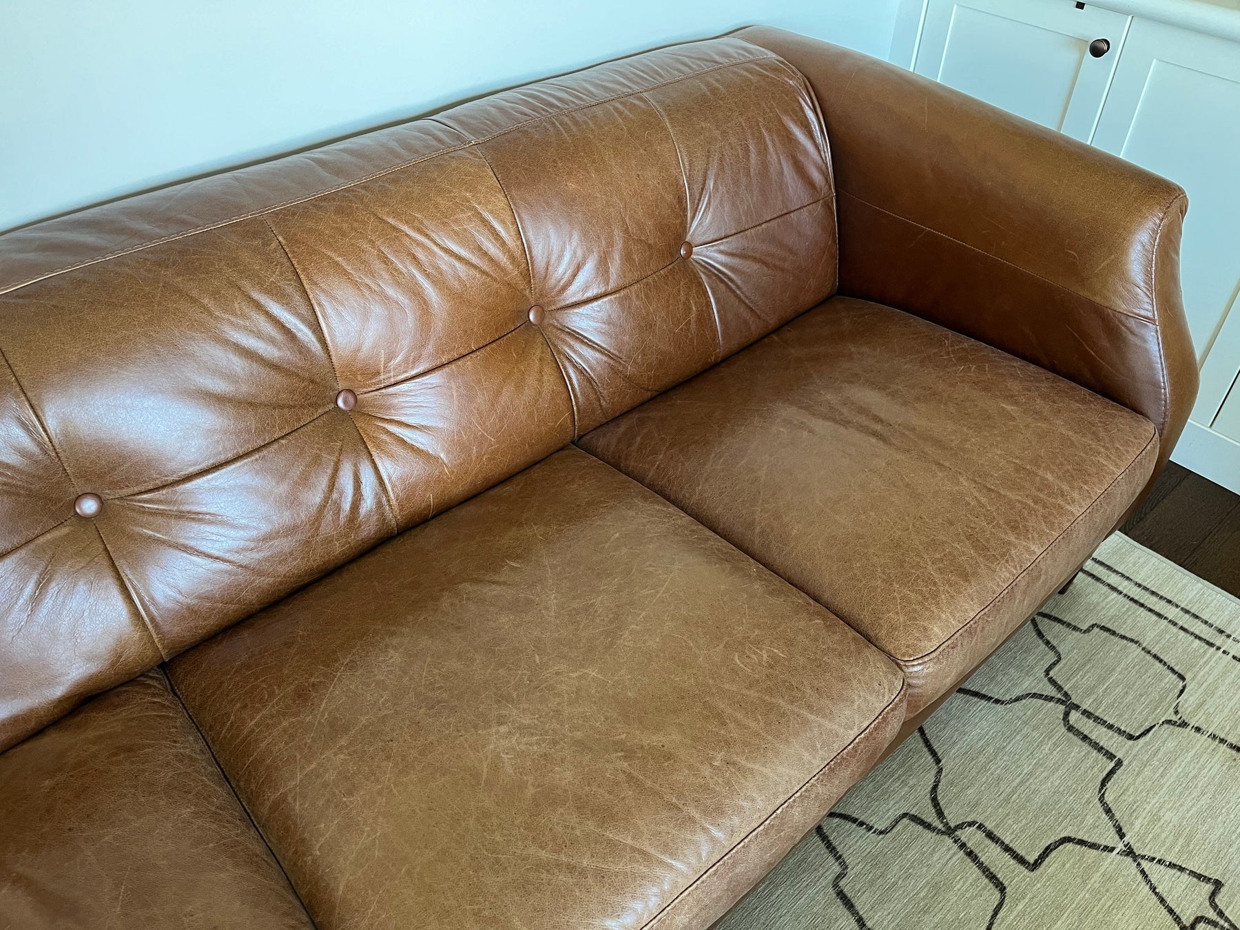 Tan brown retro couch prior to being treated with Leather Better. Very worn with scratches and cracks.