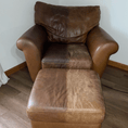 Load image into Gallery viewer, Visible restoration in progress on leather ottoman and chair. Leather Better treatment revives faded, cracked finish.
