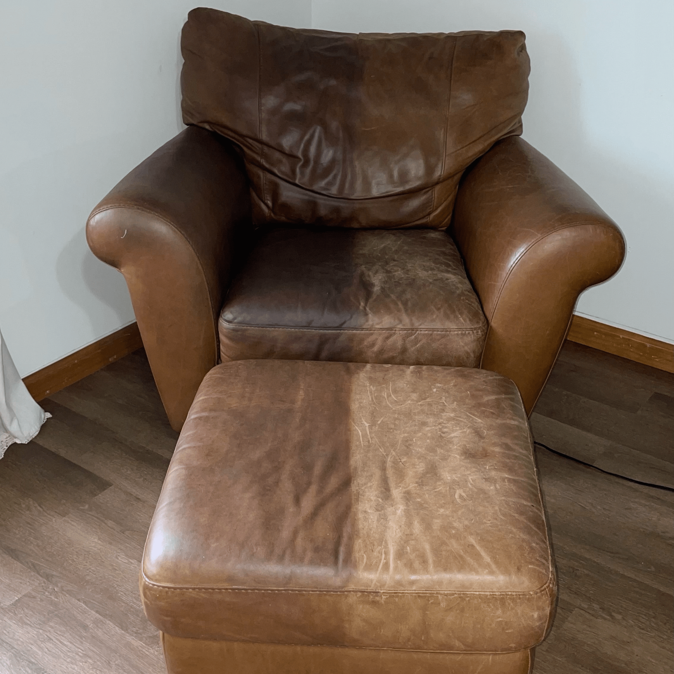 Visible restoration in progress on leather ottoman and chair. Leather Better treatment revives faded, cracked finish.