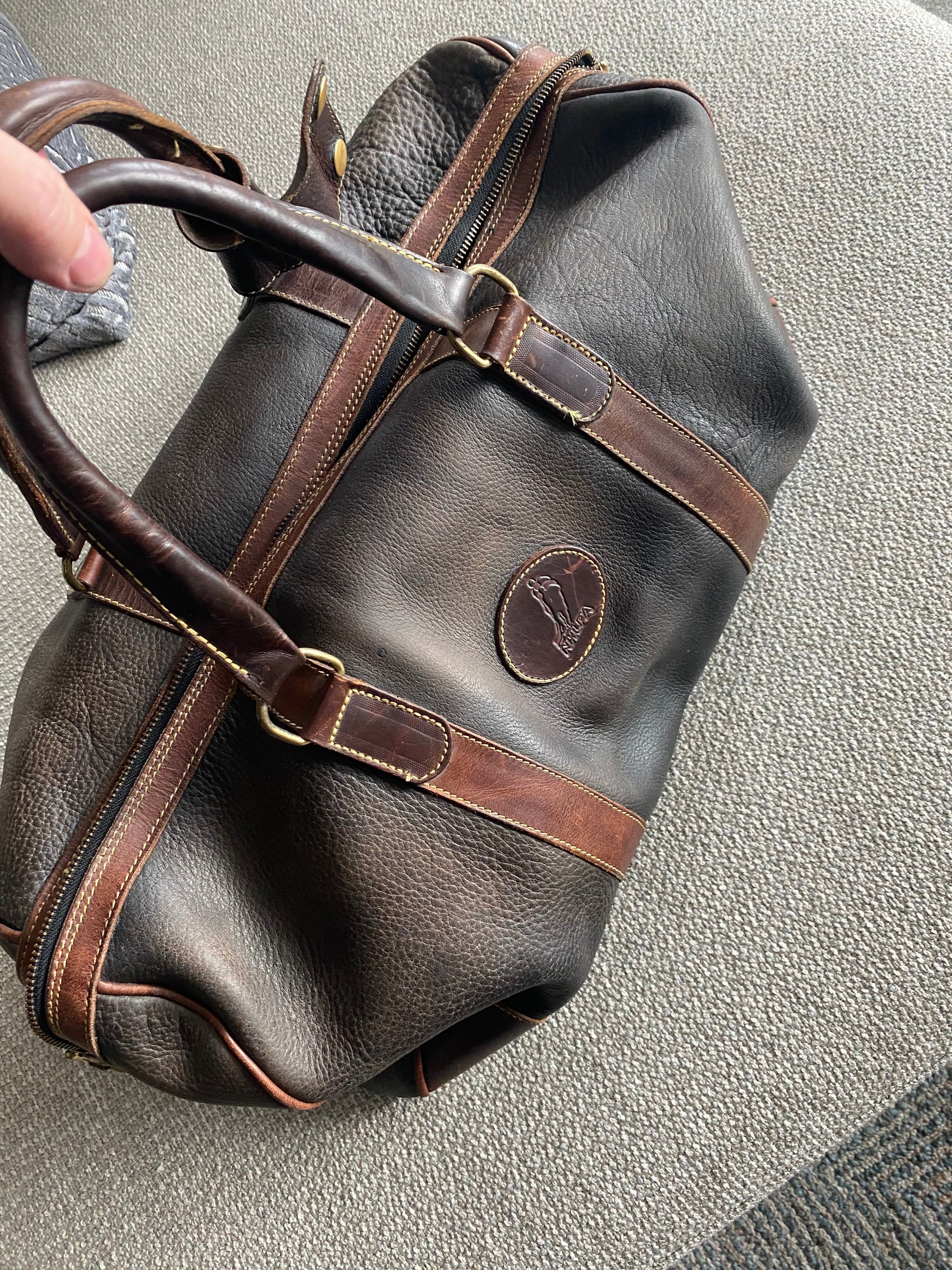 A restored weekender bag after treatment with Leather Better.  Customer, John's five star review: "Leather Better just made my go-to leather weekender bag SO worth traveling with again!  Thank you!"