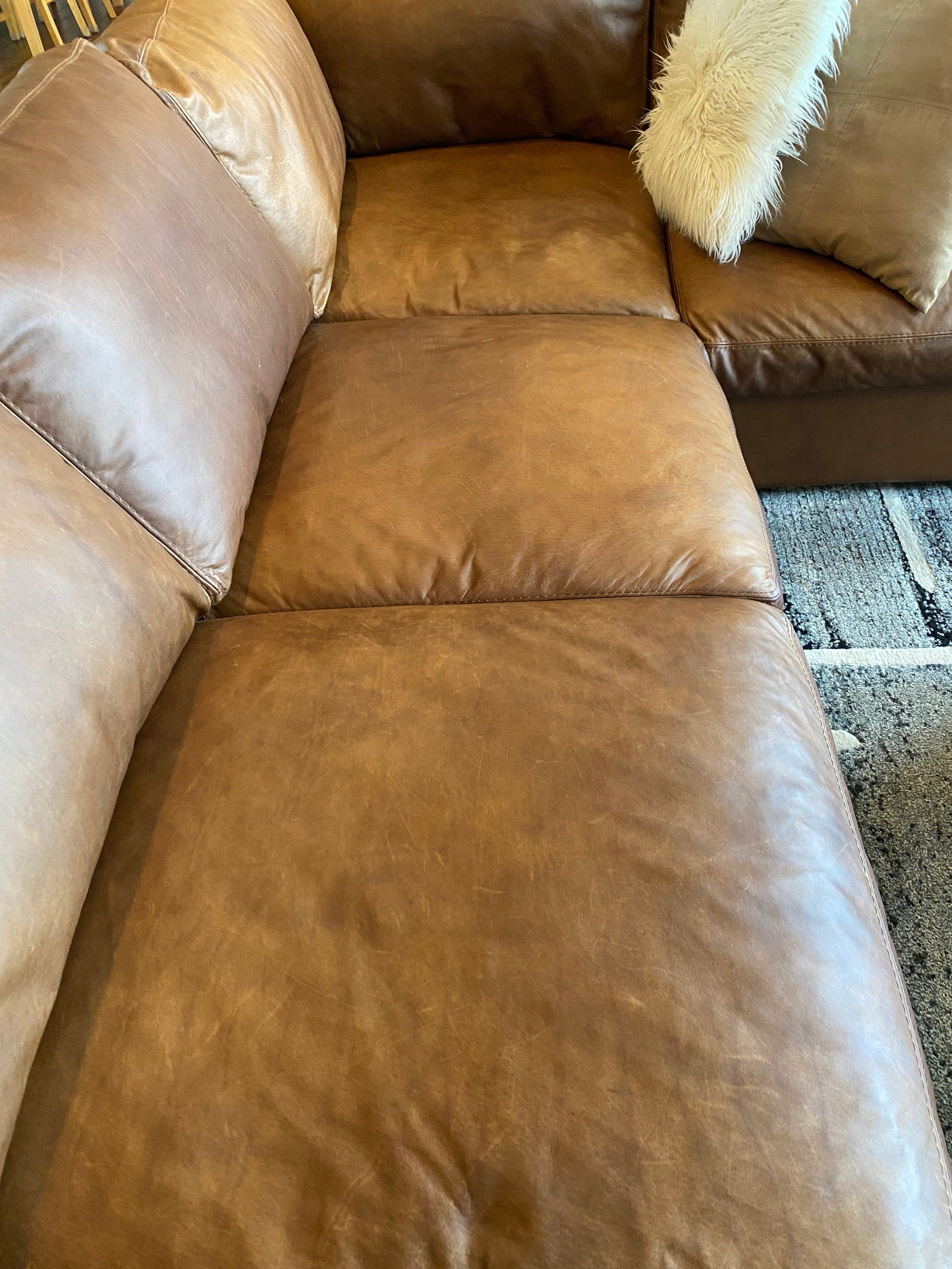 A couch transformed after being treated with Leather Better. Customer, Leatha's five star review: "This stuff is truly amazing. I brought it for my new couch it is less that a year old. My dog scratched it up pretty good and a Bench I bought 15 yrs ago. Tried many leather products and it hasn’t looked this good for a very long time. This product does what it says.  Thank you Better Leather!"
